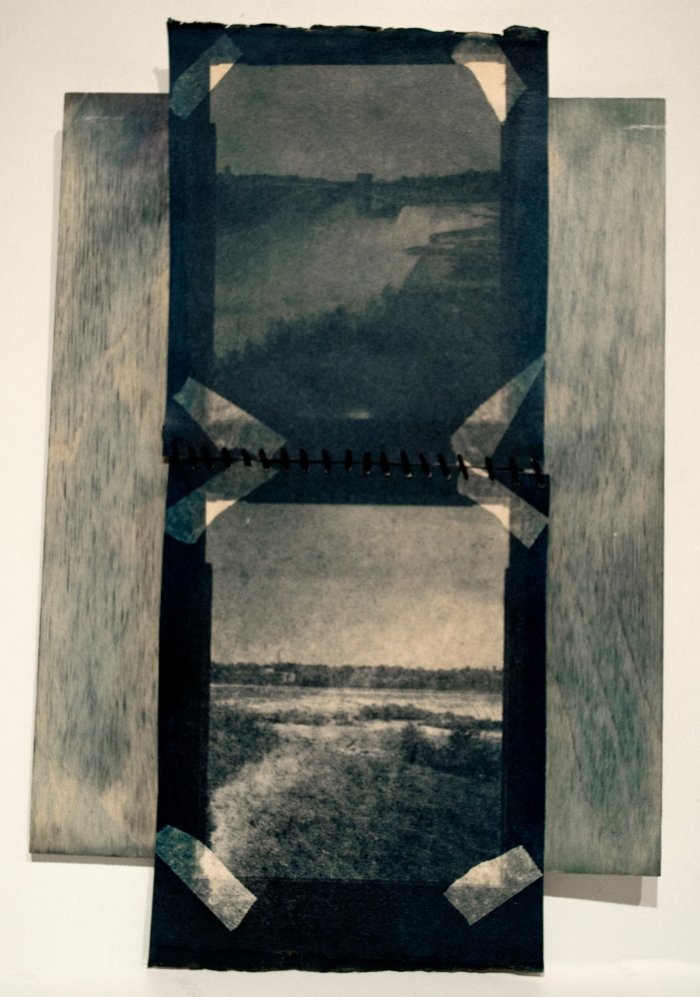 Diptic cyanotype, bleached and then toned in tea, sewn together and mounted on a wooden board.